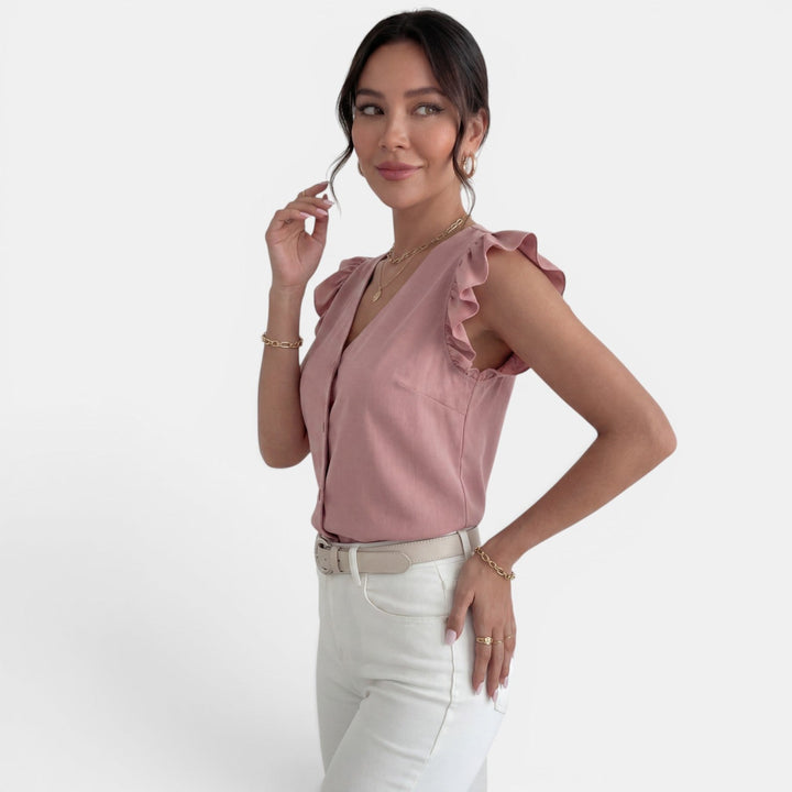 Blusa elegante de moda femenina con volantes en mangas y cuello, con botones. Versátil primavera.
