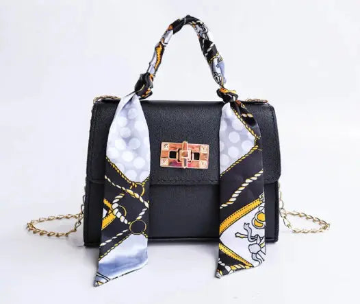 Bolso de mano sofisticado para mujer, color burdeos, con cadena removible y pañuelo estampado.