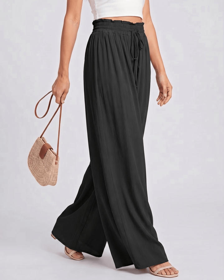 Pantalones Selene de mujer, pierna ancha, cintura alta, vista frontal, ideales para el verano.