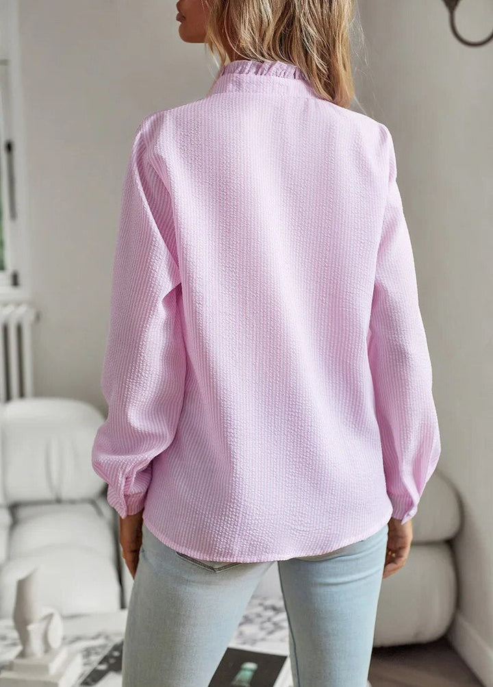 Mujer luciendo blusa elegante de manga larga. Estilo casual chic y confortable, ideal para moda femenina versátil.