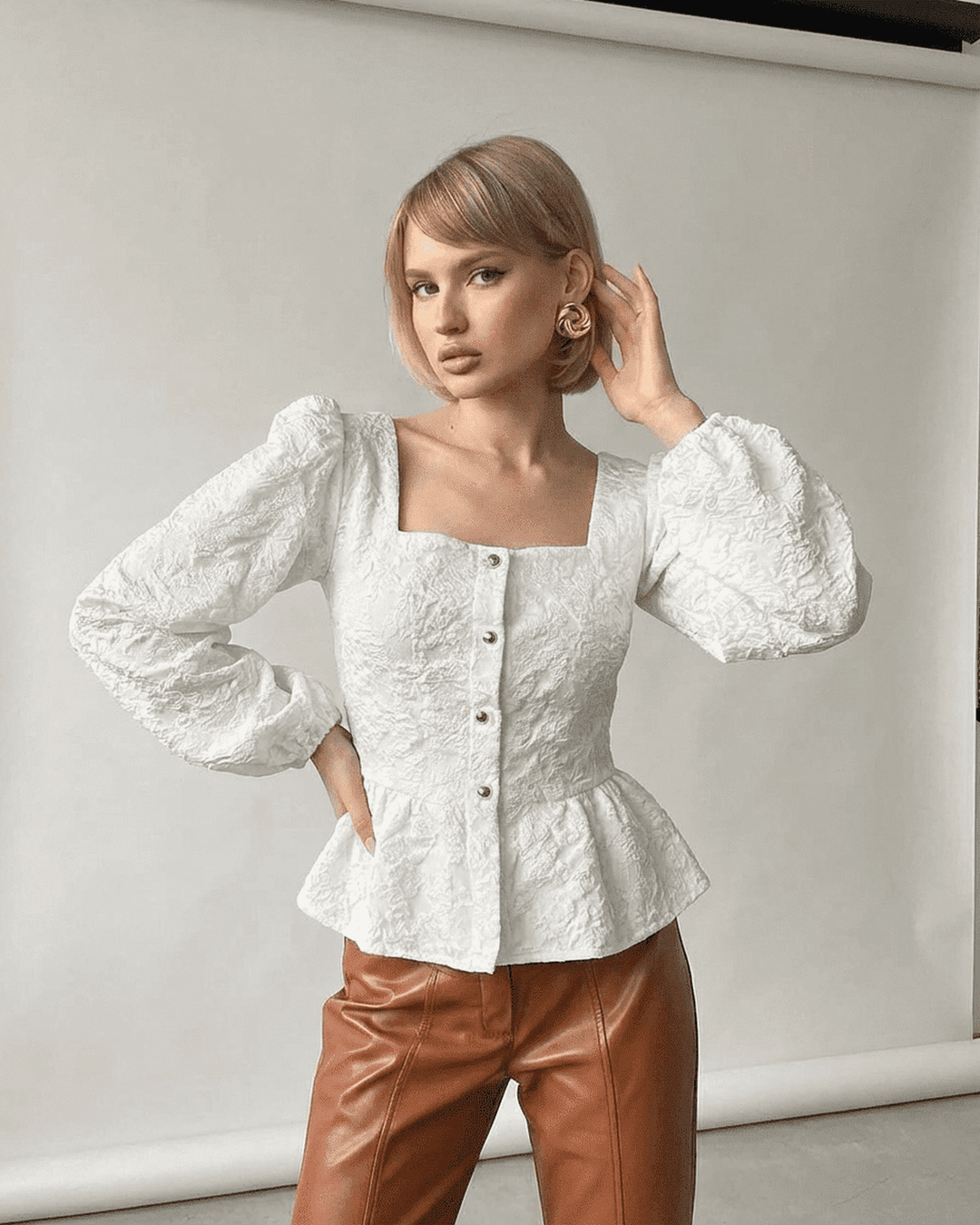 Top corsé marfil de mujer con elegantes mangas abullonadas, estilo chic.