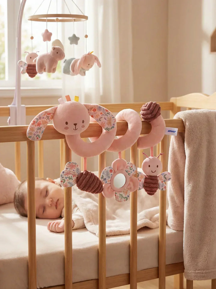 Juguete espiral sensorial para cuna con elefante y conejo rosa, estimula el desarrollo del bebé.