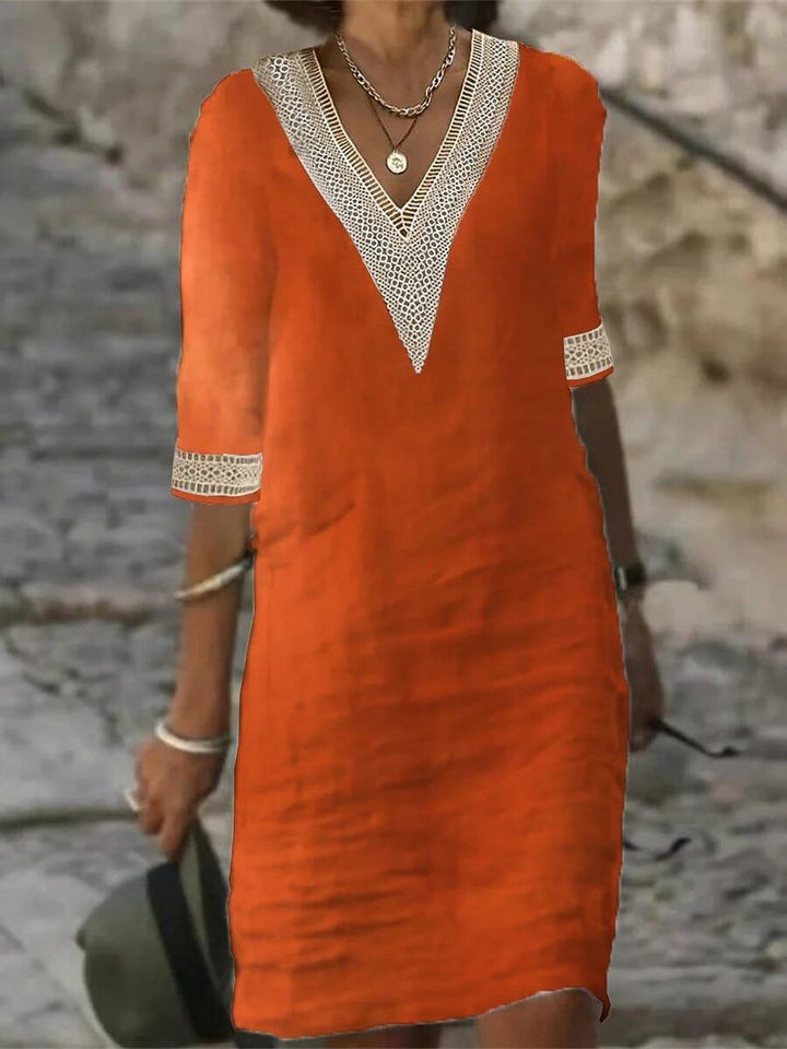 Vestido de mujer sofisticado con escote en V de encaje, perfecto para fiestas y estilo femenino.