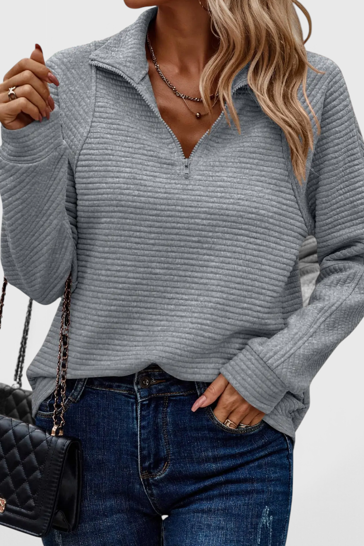 Suéter de mujer cómodo y chic con escote en V y cremallera. Perfecto para el día a día.