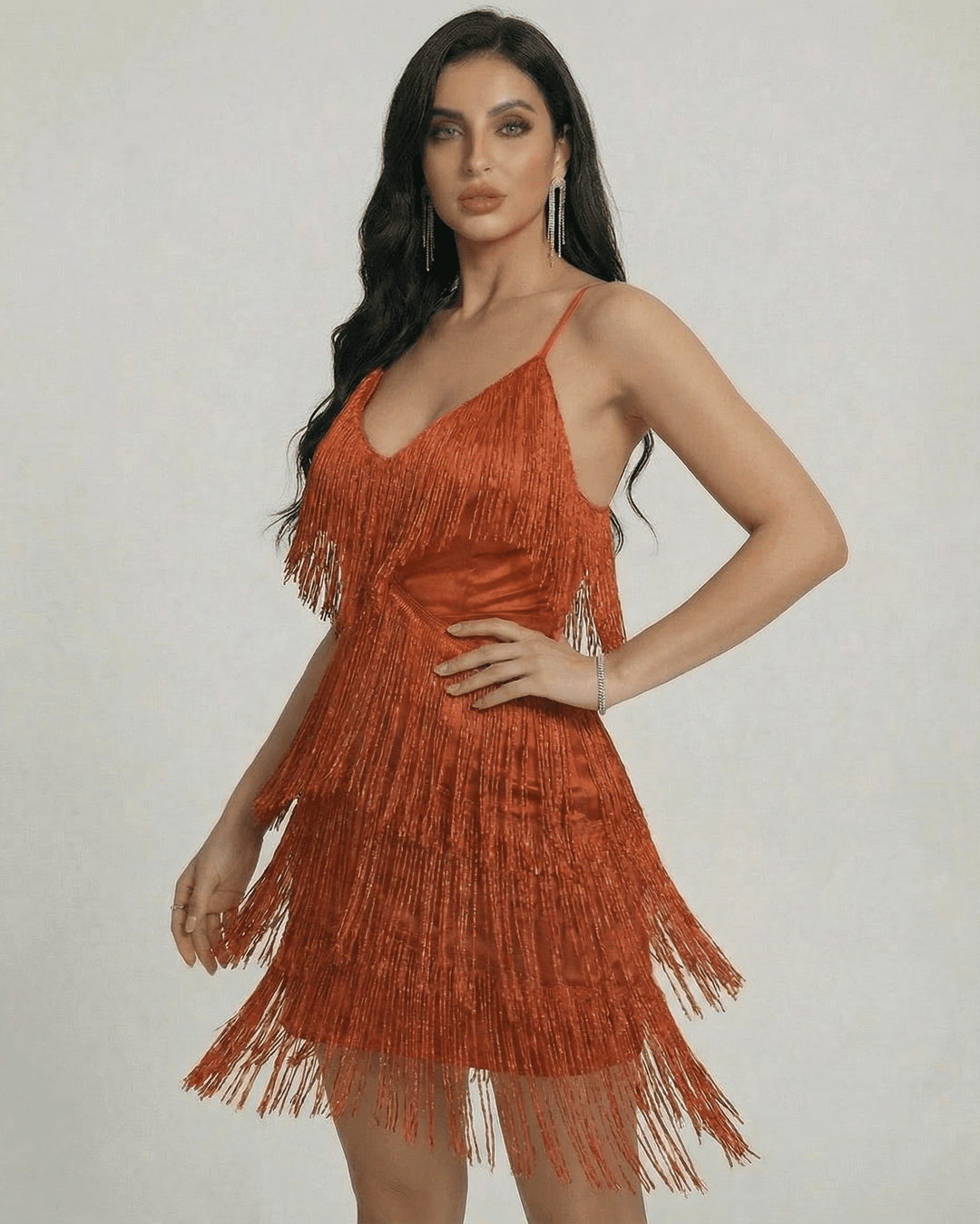 Vestido mini ámbar con flecos y estilo moderno. Ropa elegante sin mangas para mujer con movimiento.