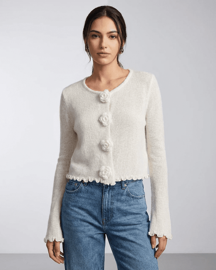 Mujer vistiendo un cárdigan blanco con botones florales, manga larga. Ideal para un estilo fresco y moderno.