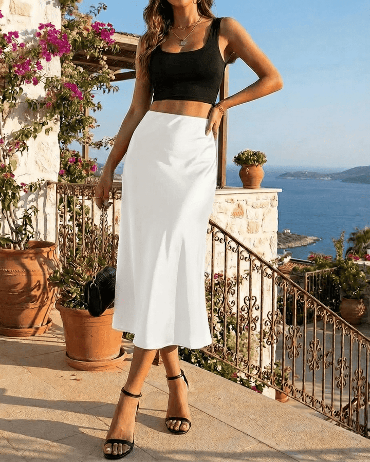 Falda midi blanca de sirena para mujer, estilo moderno y sofisticado. Una opción fluida y elegante para cualquier evento.