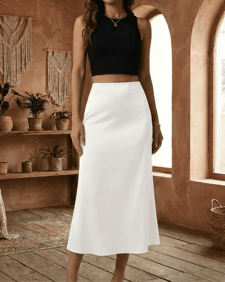 Atuendo elegante: falda midi de sirena blanca para mujer, de cintura alta y corte fluido. Ideal para moda formal.