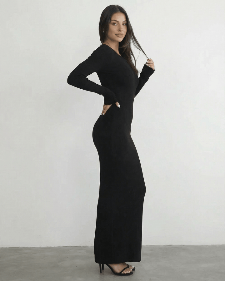 Vestido maxi negro moderno de manga larga y espalda abierta. Estilo sofisticado para mujer.