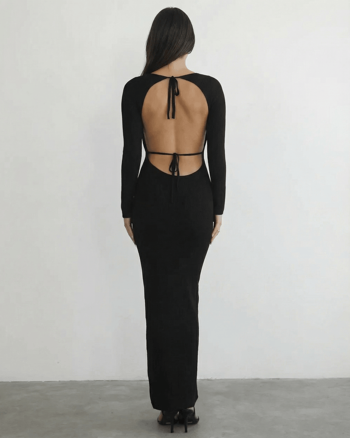 Vestido maxi negro estilizado con manga larga para mujer, detalle de espalda abierta.