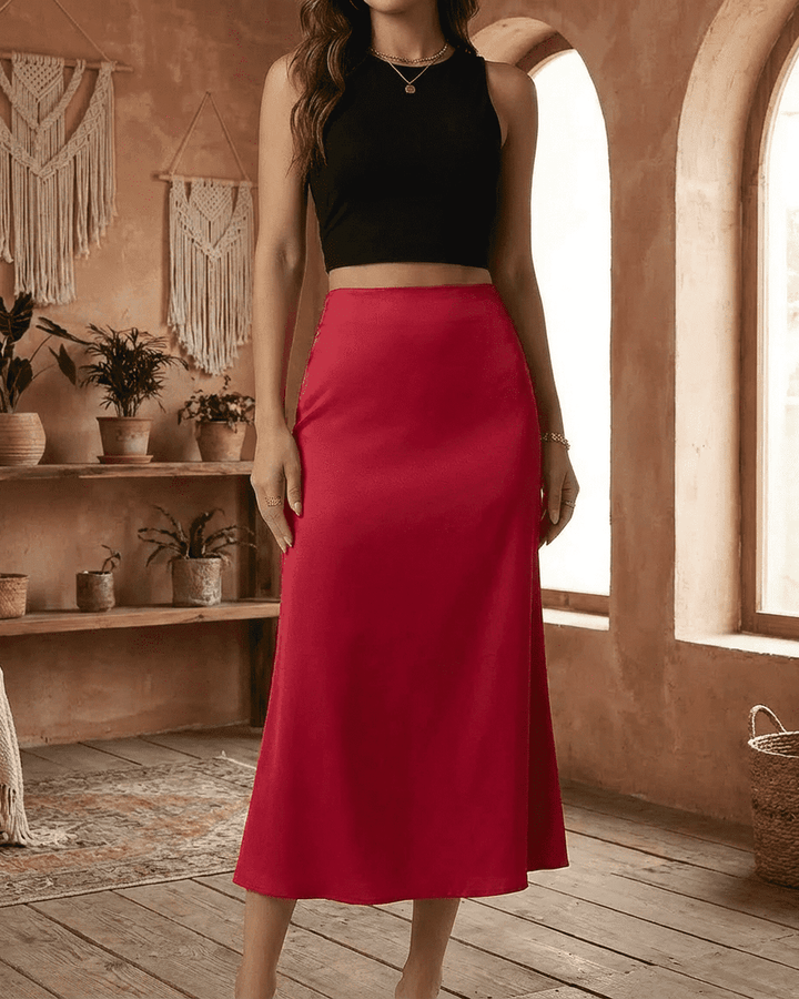 Falda midi roja Rosalia con caída elegante y corte sirena. Perfecta para lucir sofisticada en eventos y celebraciones.