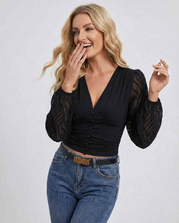 Suéter negro de mujer con diseño de mangas farol y escote en V, tendencia de moda otoño/invierno, look casual elegante.