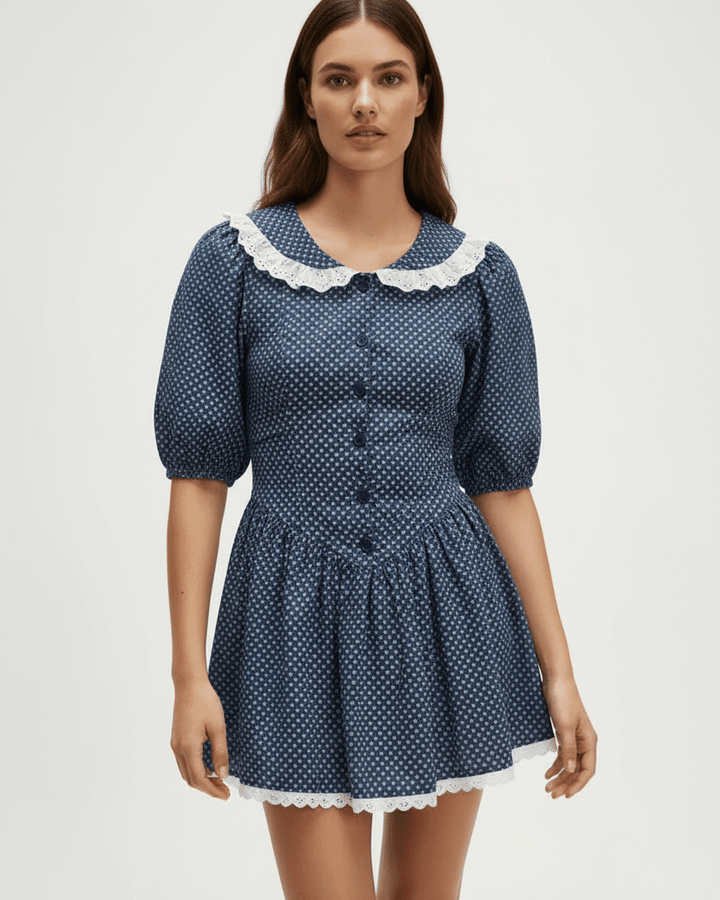 Vestido mini mujer con lunares blancos, azul marino. Cuello Peter Pan y mangas abullonadas para un estilo chic.