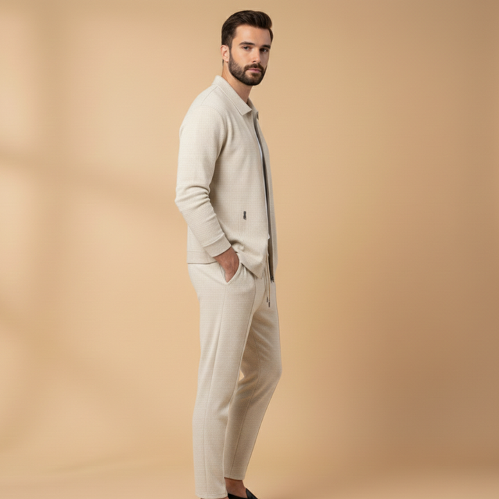 Detalle de cremallera en chaqueta de chándal para hombre, parte de un conjunto deportivo moderno y cómodo.