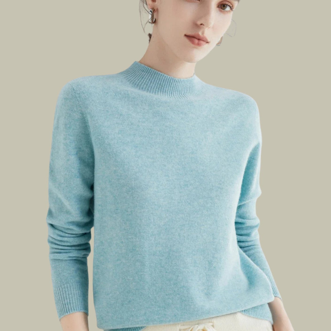 Jersey femenino de lana merina, cuello alto, suave y cálido para días fríos.