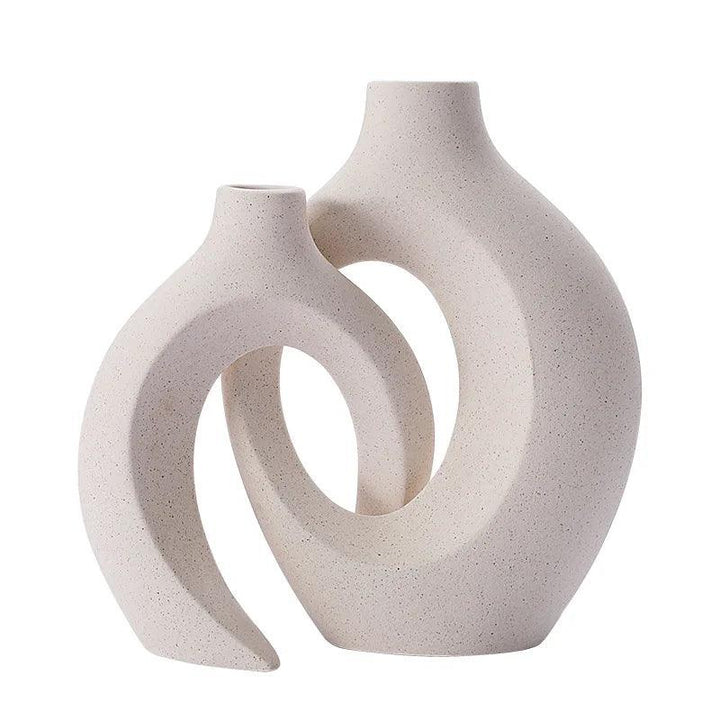 Elegante conjunto de jarrones de cerámica minimalistas, decoración versátil para cualquier interior.