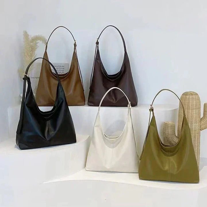 Accesorio de moda: bolso de hombro amplio y casual en tono gris, ideal para la mujer moderna.