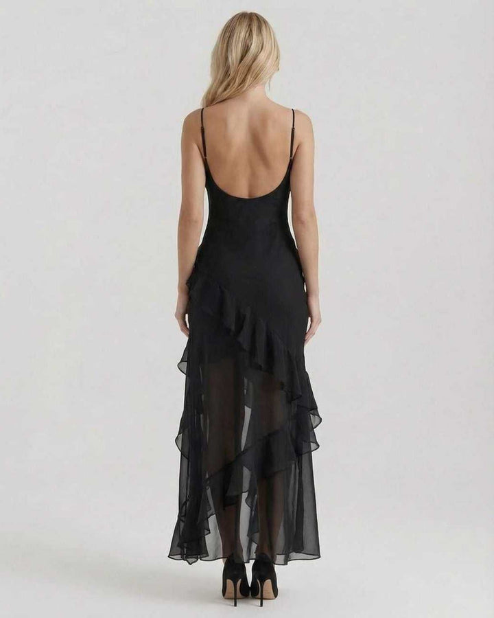 Sofisticado vestido de noche negro maxi con volantes y diseño asimétrico. Ideal para invitada de boda o fiesta.