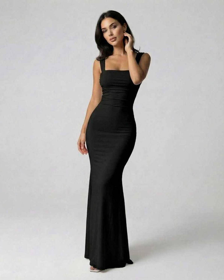 Vestido maxi negro elegante para mujer con sofisticada espalda cruzada, perfecto para noche o fiesta.