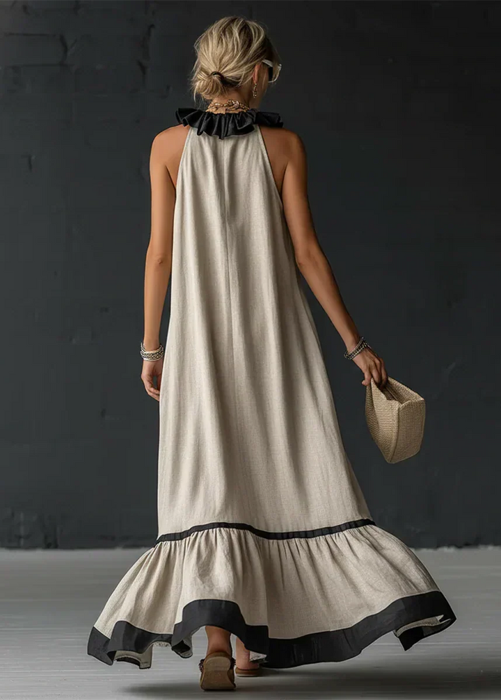 Vestido largo femenino con cuello halter y detalles de volantes, ideal para lucir en la moda de verano.