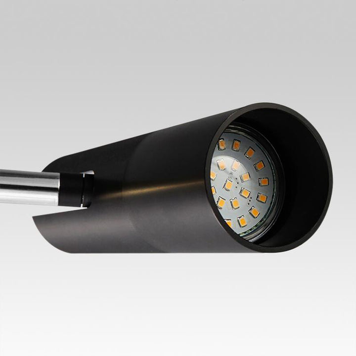 Lámpara colgante negra cilíndrica. Foco de luz focalizada para diseño interior contemporáneo y techo moderno.
