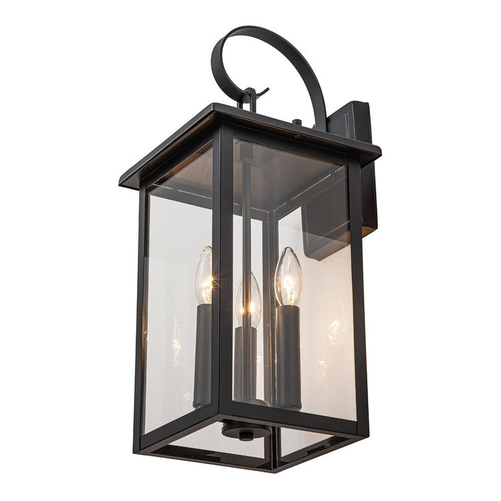 Aplique moderno industrial de 3 bombillas, acabado negro. Vidrio transparente, para una luz exterior clara.