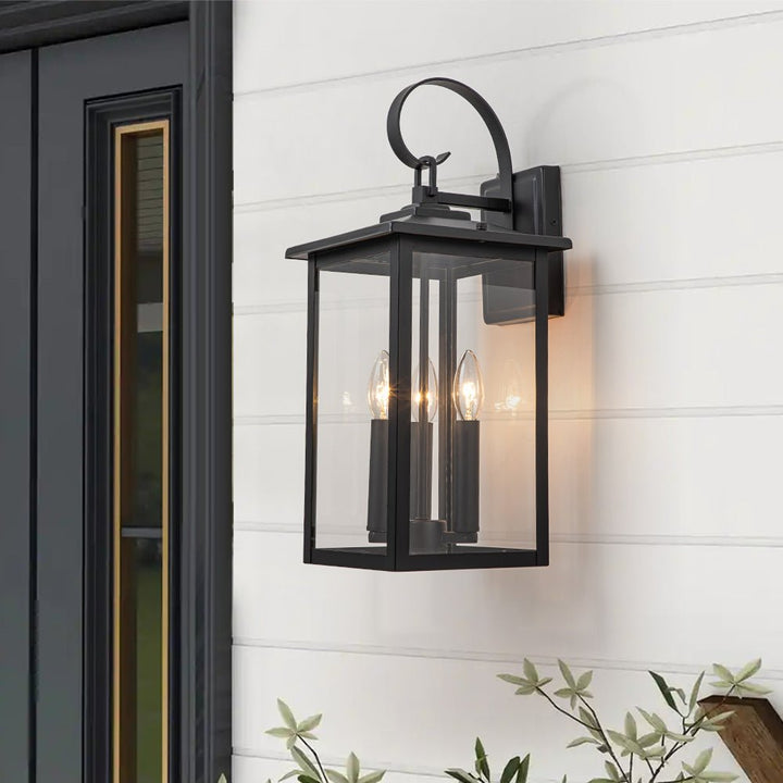 Lámpara de pared exterior moderna negra con 3 luces y vidrio claro. Iluminación elegante para jardín.