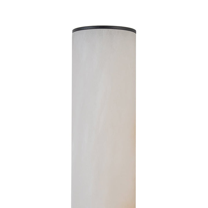 Iluminación LED moderna de pared con aplique de mármol negro y diseño cilíndrico.