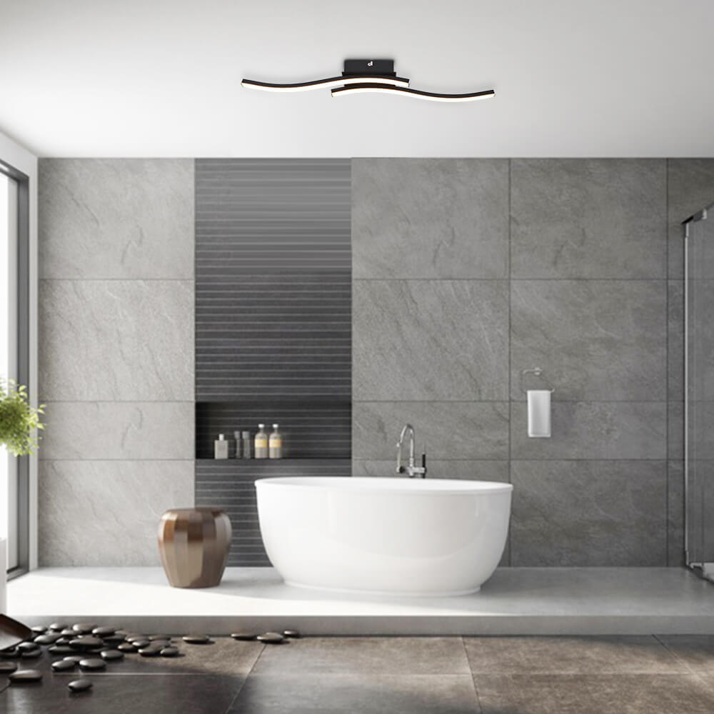 Luminaria LED moderna para baño, diseño curvo y regulable. Crea un ambiente cálido con iluminación semi empotrada.