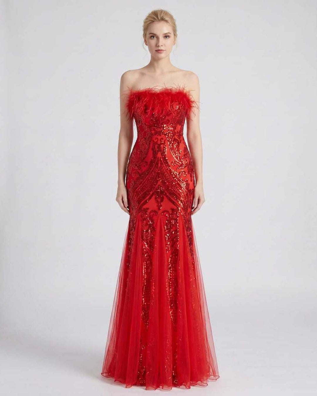 Maxi vestido con lentejuelas y plumas, silueta sirena. Para una figura deslumbrante.