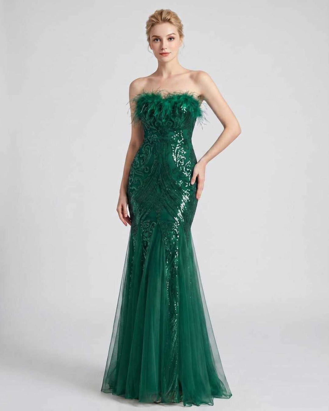 Vestido maxi con lentejuelas y plumas, hombros descubiertos. Para sentirse especial.