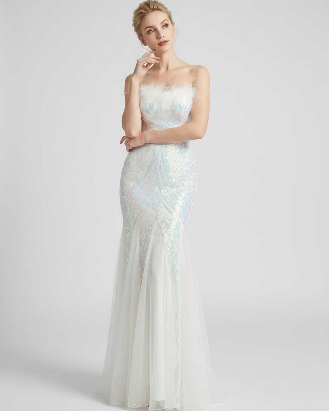 Vestido de gala sin mangas, lentejuelas brillantes y delicadas plumas. Moda mujer.