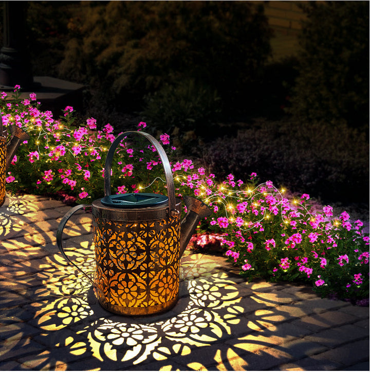 Detalle de lámpara solar de jardín con forma de regadera vintage, luz cálida para decoración e iluminación exterior.