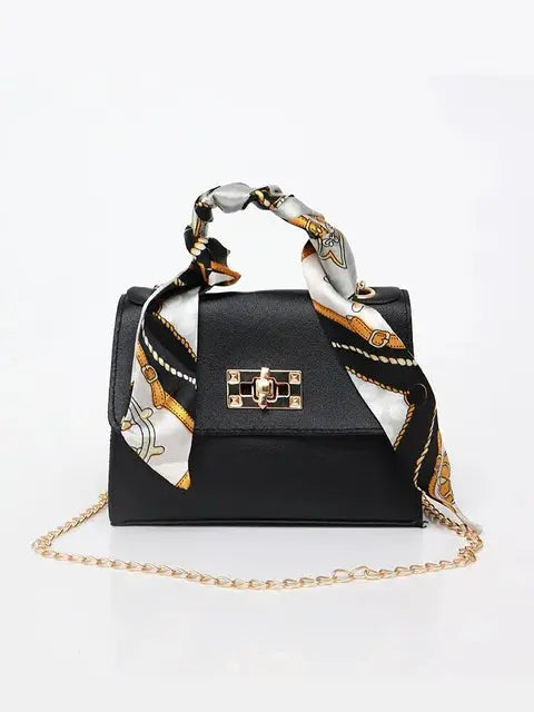 Bolso de mano elegante para mujer con cadena dorada y pañuelo decorativo de seda sintética, accesorio de moda sofisticado.