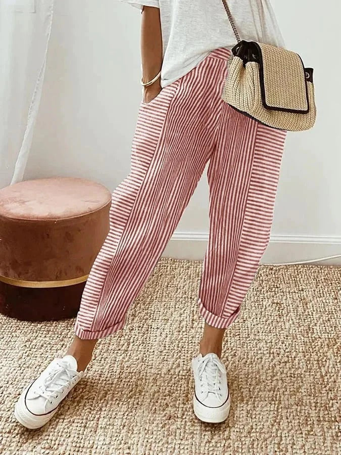 Pantalón de lino a rayas verticales para mujer. Corte fluido, cintura ajustable y bolsillos, ideal para moda cómoda de verano.