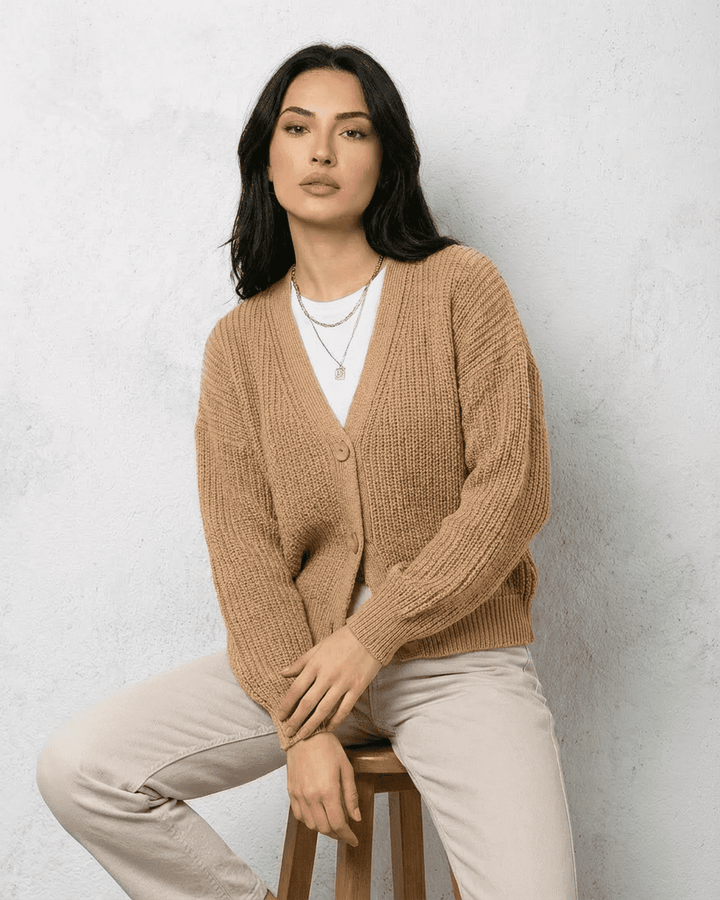 Cárdigan de punto beige para mujer que combina suavidad y estilo. Perfecto para otoño e invierno.
