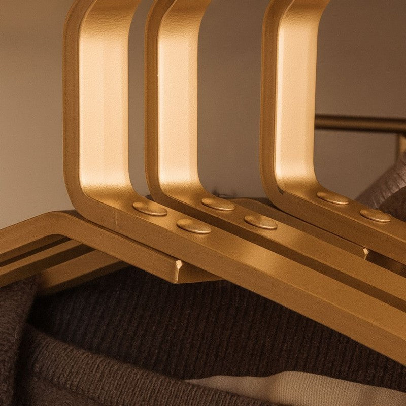Perchas compactas y elegantes para ropa. Mejoran la estética y organización del armario, ahorrando espacio.