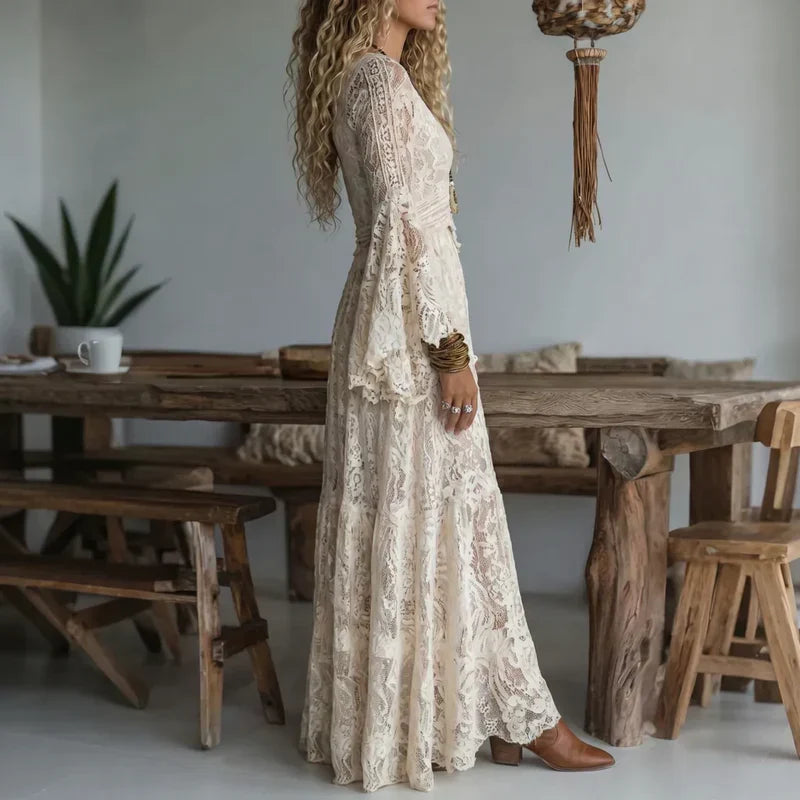 Mujer luce un vestido largo de encaje vintage con delicadas mangas acampanadas. Estilo romántico y elegante.