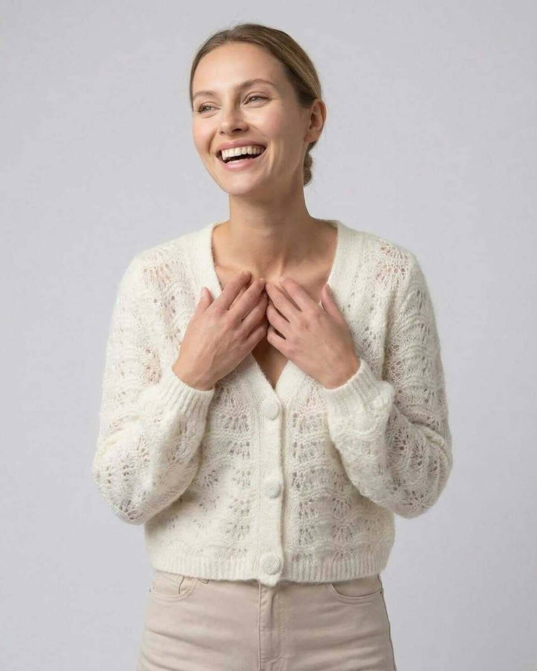 Cárdigan blanco de moda femenina. Cuello en V y manga larga. Ideal como ropa de oficina o para un estilo casual chic.