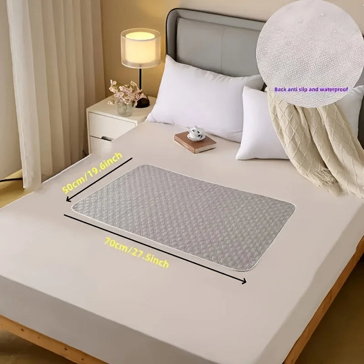 Protector de cama lavable para incontinencia, asegura higiene del colchón; absorbente, reutilizable y fácil de limpiar.