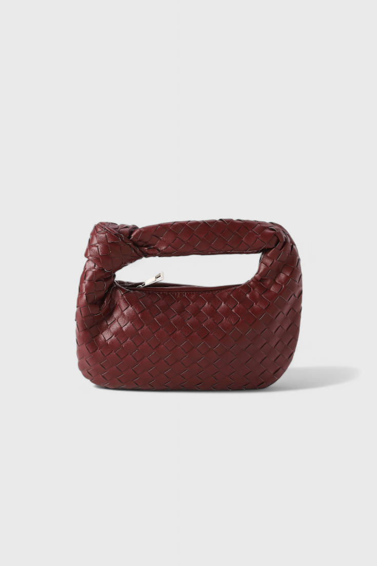 Accesorio de moda: mini bolso satchel elegante para mujer. Piel vegana tejida, un toque chic y compacto.