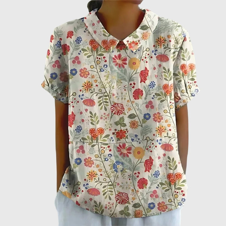 Blusa femenina de lino floral, diseño fresco y elegante para días cálidos de verano.