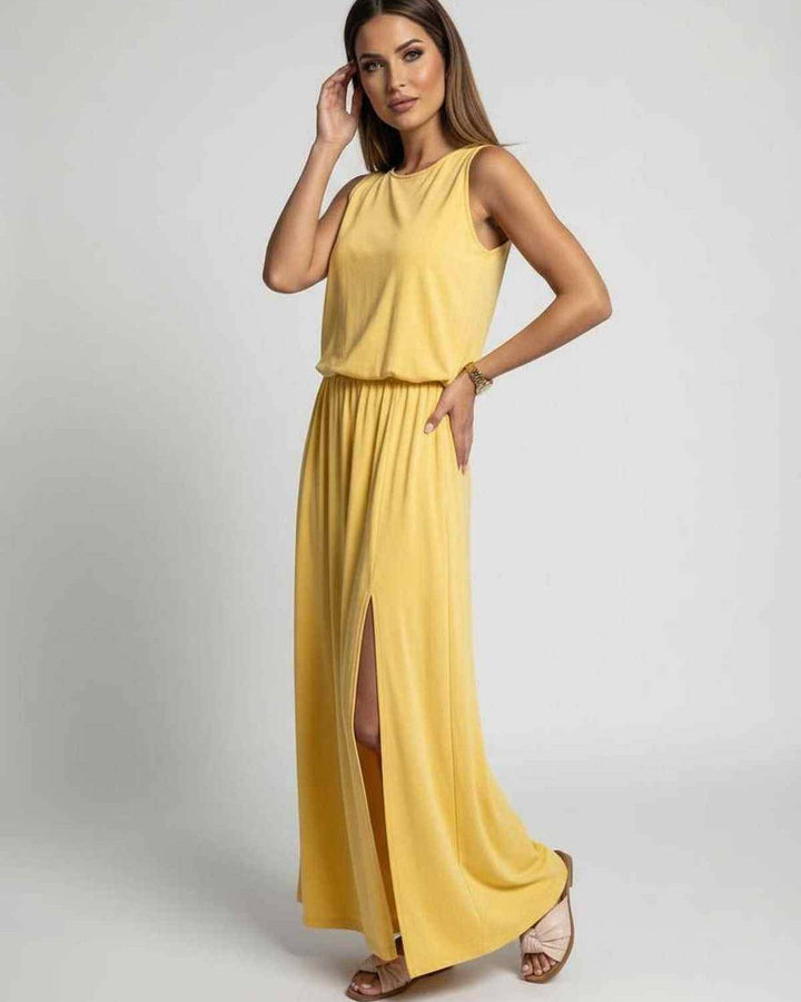 Vestido largo amarillo sin mangas y elegante, con abertura lateral. Ideal para un look casual o bohemio de verano.