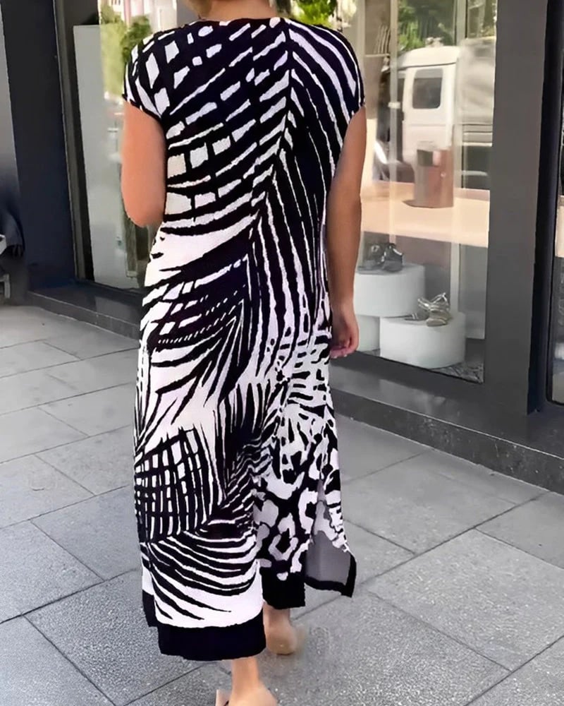 Vestido midi de mujer negro con escote V, estampado moderno y estilo boho fluido para un look casual.