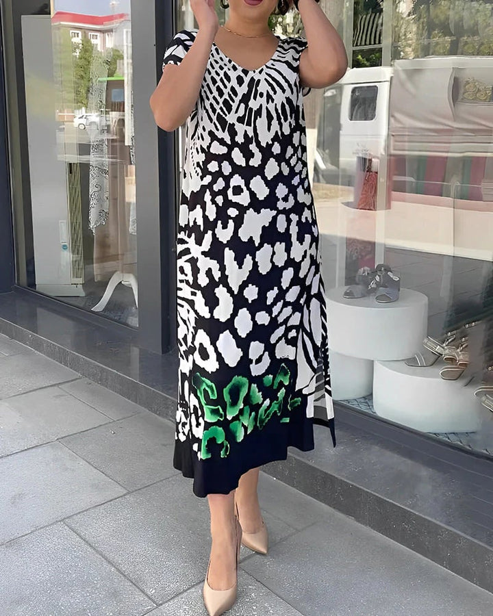Vestido midi estampado negro para mujer, casual y fluido. Moda de verano con diseño moderno y escote V.