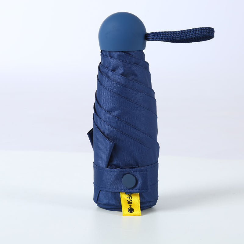 Paraguas de bolsillo compacto UPF50+ para protección UV y lluvia, ideal para viajes y uso diario.