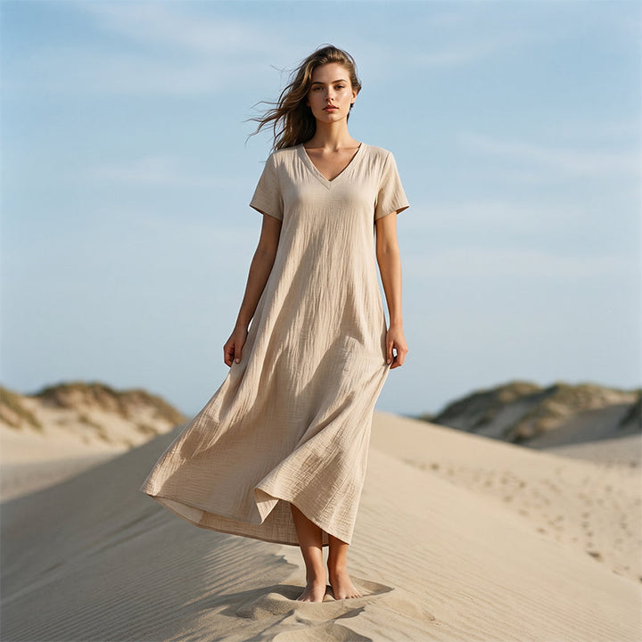 Vestido maxi femenino, cuello V, bolsillos, perfecto para vacaciones y comodidad.