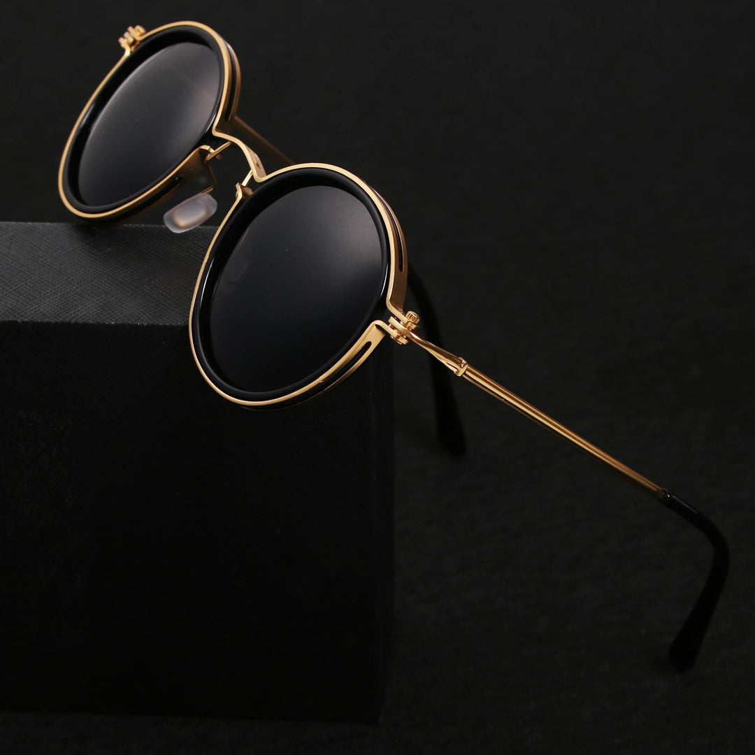 Gafas de sol de diseño atemporal, montura redonda negra, varillas doradas. Polarizadas, protección UV400. Elegancia.