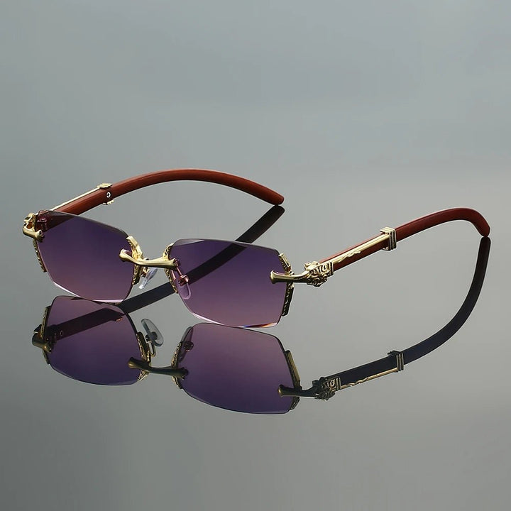Gafas de sol unisex sin montura, elegantes y ligeras con varillas doradas. Ofrecen protección UV400.