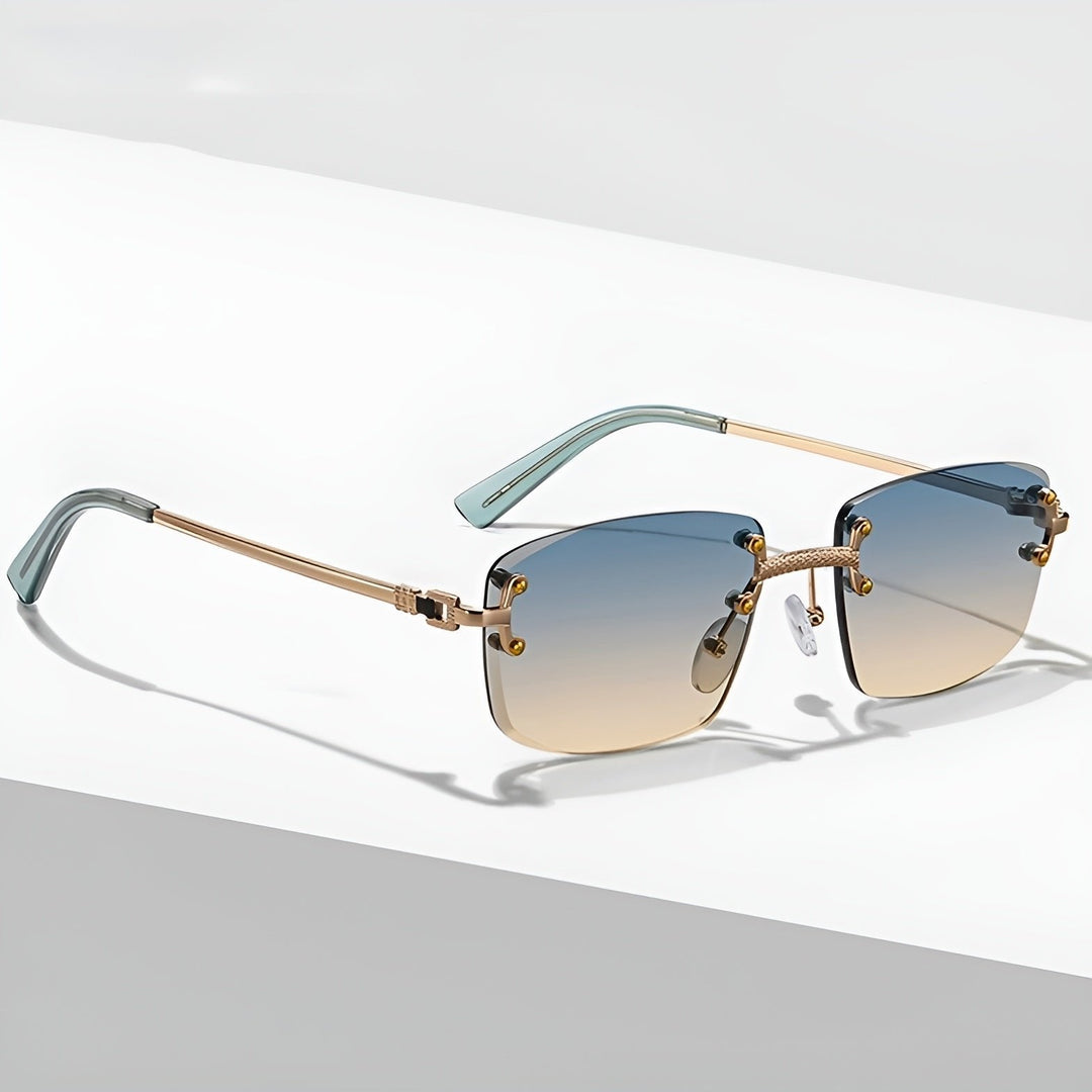 Gafas de sol unisex sin montura, lentes degradados y protección UV400. Estilo moderno, varillas doradas.